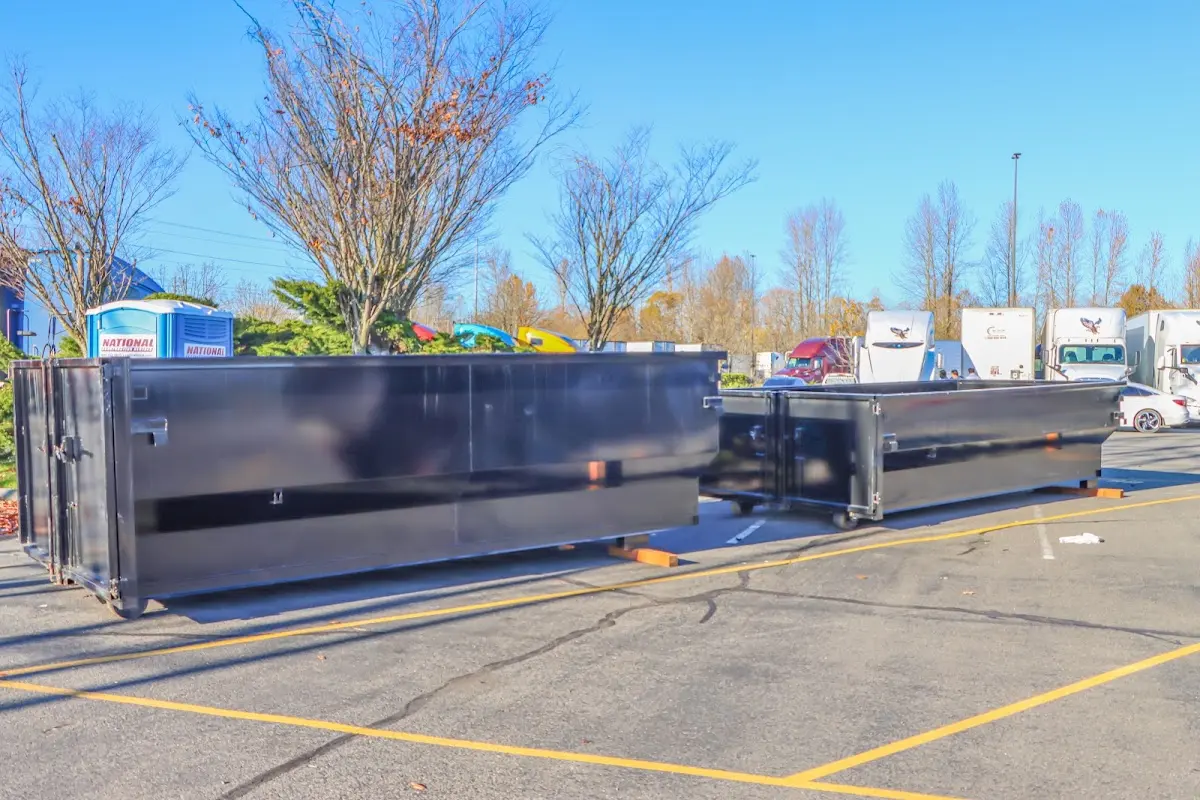 Professional dumpster rental service with roll-off container on residential driveway in Alamo Heights